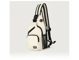 Detail view of cream canvas chest bag featuring black zippers and mesh side pocket