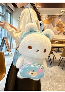 Close-up of fluffy white plush rabbit backpack with pastel gradient straps on a model