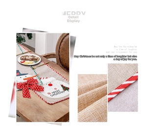 Detail of Christmas table runner with burlap texture, Santa appliqué, and red piping edge