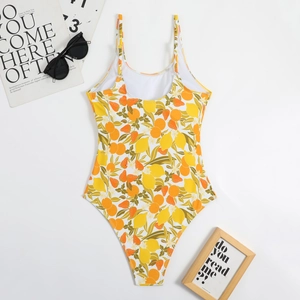 Flat lay of a one-piece swimsuit with vibrant lemon and strawberry prints and U-back detail
