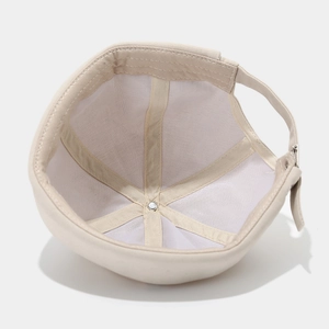 Detail view of beige miki hat interior with six-panel structure and metal buckle