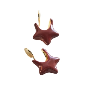 Star-shaped burgundy enamel earrings with gold metal plating shown on a clean background