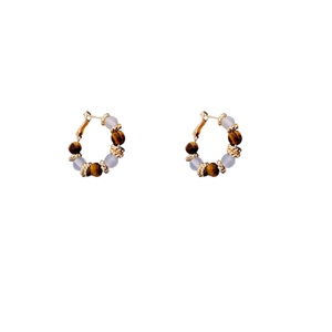 Elegant gold plated hoop earrings with white beads and brown tiger eye stones on white background