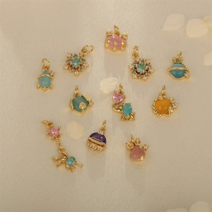 Gold-plated animal and star charms with colorful crystals on soft beige satin