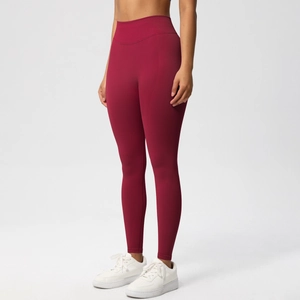 Close-up of high-waisted dark red seamless yoga leggings with peach butt lifting design