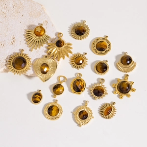 Flat lay of multiple gold DIY pendants with brown tiger eye stones in various shapes