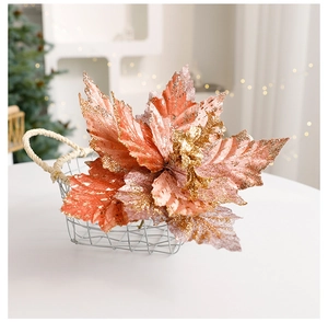 Detail of red poinsettia Christmas flower with gold glitter edges in a metal basket
