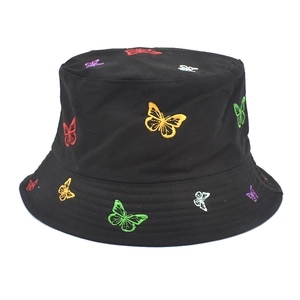 Close-up of colorful butterfly embroidery on a black cotton canvas bucket hat fabric