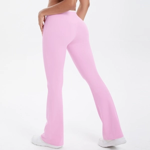 Detail view of pink high-waist flared yoga pants showing slimming fit and elastic fabric