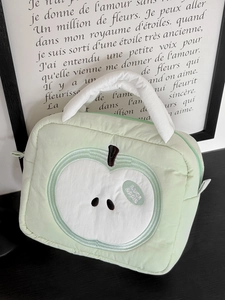 Mint green quilted apple cosmetic bag with soft white handle for travel storage
