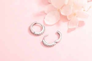 Macro shot of S925 sterling silver hoop earrings featuring clear cubic zirconia stones