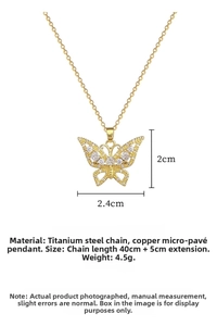 Detailed view of gold butterfly pendant with crystals and dimensions on white background