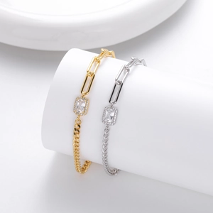 Detailed view of silver and gold chain bracelets with rectangular cubic zirconia accents