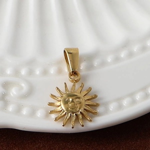 Detailed view of a gold-plated stainless steel sun pendant with embossed facial features