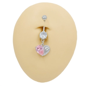 Detail of pink heart zircon belly button ring with silver feather pendant on model