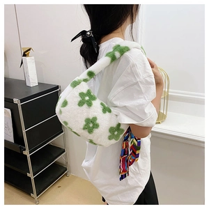 Detail of plush shoulder bag with green flower pattern and colorful silk scarf accessory