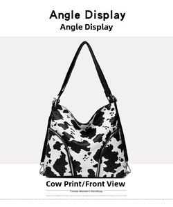 Front view of cow print hobo bag with decorative zippers and a wide black shoulder strap