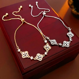 Gold and silver four-leaf clover bracelets with sparkling stones and adjustable clasp