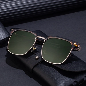 Classic browline polarized sunglasses with tortoise frame and green lenses on leather case