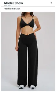 Detail of high-waist crossover yoga pants and twisted sports bra in premium black