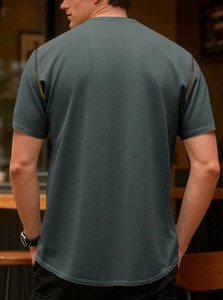 Detail of waffle knit texture and contrast shoulder stitching on men's retro polo shirt