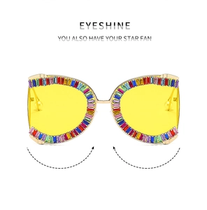 Detail of butterfly metal frame sunglasses with multi-color rhinestones and yellow lenses
