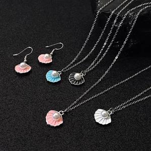 Chic shell necklace and earrings set with pearl inlay in various colors on dark stone