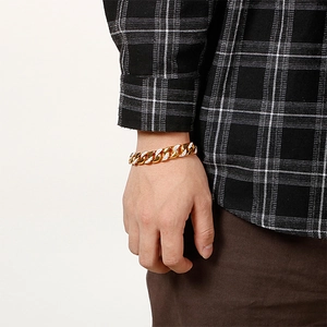 Macro detail of 18K gold-plated Cuban link bracelet with sparkling diamond-set accents
