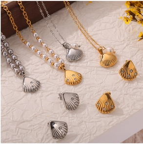 Detail of pearl necklace and shell earrings set with sparkling rhinestones in gold and silver