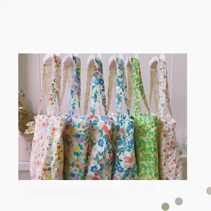Close-up of various floral cotton tote bags with colorful vintage pastoral patterns
