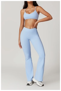Detail of light blue high waist flare yoga pants featuring a slimming cross V-shaped waistband