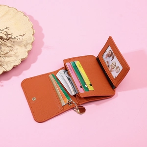 Short orange faux leather bifold wallet for women with card slots and key ring charm