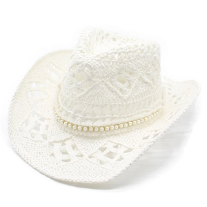 Detail of white hollow woven cowboy straw hat featuring elegant pearl band and gold beads