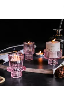 Detail of ribbed purple glass candle holders for luxury Nordic dinner table setting