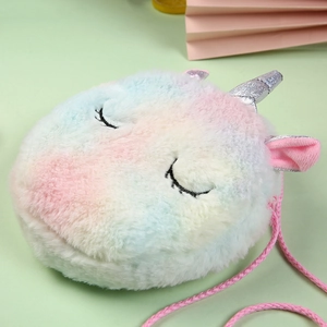 Macro shot of colorful rainbow plush unicorn bag with soft faux fur texture and silver horn