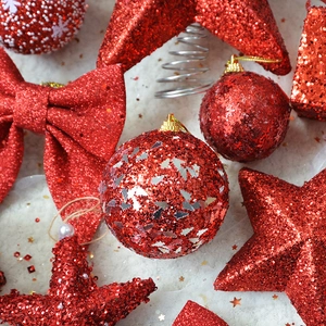 Sparkly red glitter Christmas ball ornaments with stars and bows for tree decoration