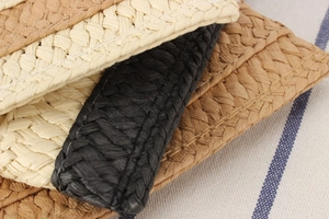 Detailed macro view of woven paper fiber bag featuring multi-colored striped texture
