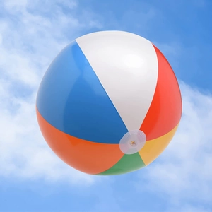 Classic inflatable PVC rainbow beach ball for outdoor pool parties against blue sky