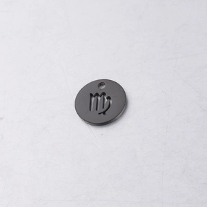 Detail of black titanium steel round pendant with engraved Virgo zodiac sign symbol