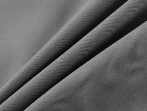 Macro shot of dark grey high-density fabric texture and drape of the mini skirt