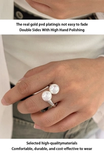 Detail of PVD silver plated stainless steel ring with white pearl on a female finger