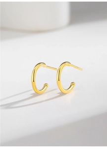 Detailed close-up of golden S925 sterling silver minimalist C-shaped stud earrings
