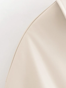 Detailed close-up of cream faux leather jacket with high-quality stitching and texture