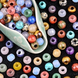 Mixed natural amethyst and agate 12mm large hole beads spilling from a ceramic spoon