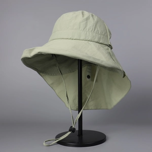 Detail of sage green sun hat with wide brim, neck flap and adjustable windproof cord