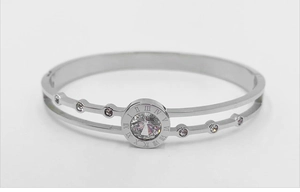 Detail of silver layered bracelet featuring Roman numeral dial and sparkling zircon
