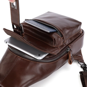Brown leather chest bag interior view showing space for a tablet and passport