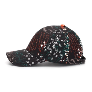 Detail of baseball cap showing abstract floral prints and vibrant geometric patterns