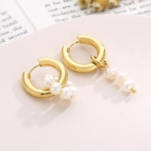 Detailed close-up of gold titanium hoop earrings with elegant white pearl pendants