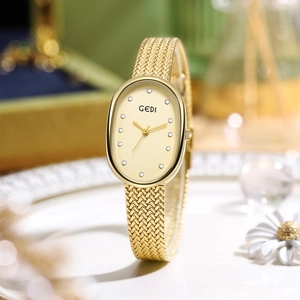 Luxury oval mother-of-pearl women watch with gold mesh strap and crystal dial markers